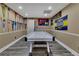 Finished basement game area with luxury vinyl plank flooring, recessed lighting, and sports team decor at 3028 Towneside Ln, Woodstock, GA 30189