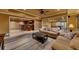 Finished basement living room area with neutral decor, luxury vinyl plank flooring, and wet bar at 3028 Towneside Ln, Woodstock, GA 30189