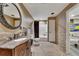 Nicely finished bathroom with decorative mirror, a single vanity, and tiled flooring at 3028 Towneside Ln, Woodstock, GA 30189