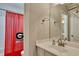 Modern bathroom with tiled shower behind red Georgia Bulldog shower curtain at 3028 Towneside Ln, Woodstock, GA 30189