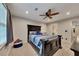 Bright bedroom featuring a ceiling fan, a queen-sized bed, and a large window at 3028 Towneside Ln, Woodstock, GA 30189