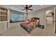 Cozy bedroom with a window seat, built-in shelves, and a comfortable bed with colorful accents at 3028 Towneside Ln, Woodstock, GA 30189