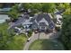 Stunning aerial view of clubhouse featuring manicured lawns, tennis courts, and ample parking for residents and guests at 3028 Towneside Ln, Woodstock, GA 30189