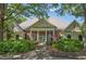 Charming community center featuring a brick facade, stately columns, and a manicured lawn at 3028 Towneside Ln, Woodstock, GA 30189
