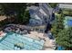 Wonderful community pool featuring lounge chairs, main building and mature trees and landscaping at 3028 Towneside Ln, Woodstock, GA 30189