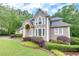 Elegant home with lush landscaping, showcasing its architectural details and curb appeal at 3028 Towneside Ln, Woodstock, GA 30189