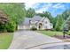 Beautiful home with a spacious driveway leading to a three-car garage and lovely front yard at 3028 Towneside Ln, Woodstock, GA 30189