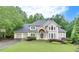 Charming two-story home featuring a three-car garage and a well-manicured front lawn at 3028 Towneside Ln, Woodstock, GA 30189