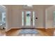 Bright foyer featuring a decorative glass front door, hardwood floors, and a patterned rug at 3028 Towneside Ln, Woodstock, GA 30189