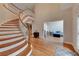 Spacious foyer with a curved staircase, hardwood floors, and views into the living spaces at 3028 Towneside Ln, Woodstock, GA 30189