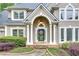 Inviting front entrance with stone pathway, columns, and a decorative wreath on the door at 3028 Towneside Ln, Woodstock, GA 30189