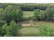Scenic view of a lush golf course with a sand trap surrounded by mature trees at 3028 Towneside Ln, Woodstock, GA 30189