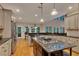 Spacious kitchen with granite countertops, stainless steel appliances, and hardwood floors offers a chef's delight at 3028 Towneside Ln, Woodstock, GA 30189