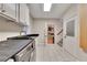 Spacious laundry area boasting tile floors, black countertop, and convenient access to the staircase at 3028 Towneside Ln, Woodstock, GA 30189