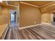 Spacious living area featuring hardwood flooring, neutral walls, and a seating bench against the wall at 3028 Towneside Ln, Woodstock, GA 30189