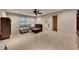 Spacious living room with neutral carpet, ceiling fan, and cozy gray sofa with ottoman at 3028 Towneside Ln, Woodstock, GA 30189