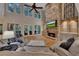 Inviting living room featuring a stone fireplace, built-in cabinets, and large windows at 3028 Towneside Ln, Woodstock, GA 30189