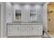 A stunning main bathroom with dual vanities, granite countertops, and a glass-enclosed shower creates a luxurious retreat at 3028 Towneside Ln, Woodstock, GA 30189