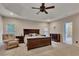 A serene main bedroom features a cozy sitting area, tray ceiling, and neutral decor for ultimate relaxation at 3028 Towneside Ln, Woodstock, GA 30189