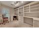 Bright office featuring custom built-in shelving, a large window, and neutral carpet at 3028 Towneside Ln, Woodstock, GA 30189
