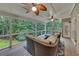 Relaxing screened porch with ceiling fans, comfortable wicker seating, and a view of the wooded backyard at 3028 Towneside Ln, Woodstock, GA 30189