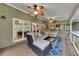 Inviting screened porch with ceiling fans, cozy seating, and serene view of the surrounding woods at 3028 Towneside Ln, Woodstock, GA 30189