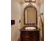 Elegant powder room with a custom vanity, ornate mirror, and classic fixtures creates a sophisticated space at 3028 Towneside Ln, Woodstock, GA 30189