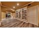 Basement recreational room featuring hardwood floors, built-in bookshelves, and a game area at 3028 Towneside Ln, Woodstock, GA 30189
