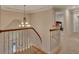 Foyer staircase with hardwood stairs and white railing leading to the second floor at 3028 Towneside Ln, Woodstock, GA 30189