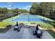 Community tennis courts with shaded benches and a nearby lounge area at 3028 Towneside Ln, Woodstock, GA 30189