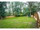 Well-maintained backyard with lush green lawn and mature trees, offering privacy at 4409 Woodward Mill Rd, Sugar Hill, GA 30518