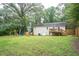 Open backyard with a playground set, a trampoline, and a deck at 4409 Woodward Mill Rd, Sugar Hill, GA 30518