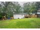 Large backyard with a well-kept lawn, a playground set, and access to a deck at 4409 Woodward Mill Rd, Sugar Hill, GA 30518