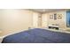 Large basement bedroom features a bed, two doors and a play area at 4409 Woodward Mill Rd, Sugar Hill, GA 30518