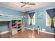 Bedroom displaying blue walls, wood floors, and two windows at 4409 Woodward Mill Rd, Sugar Hill, GA 30518