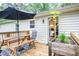Exterior view of a home's wooden deck and patio with a table and chairs at 4409 Woodward Mill Rd, Sugar Hill, GA 30518
