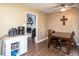 Cozy dining area with a wood table, ceiling fan, and doorway to another room with a fireplace at 4409 Woodward Mill Rd, Sugar Hill, GA 30518