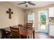 Warm dining area with a wood table, backyard deck entrance and ceiling fan at 4409 Woodward Mill Rd, Sugar Hill, GA 30518