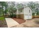View of the house with a two-car garage and a well-maintained lawn at 4409 Woodward Mill Rd, Sugar Hill, GA 30518