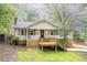 Charming home with a front porch, light siding, and a well-maintained yard at 4409 Woodward Mill Rd, Sugar Hill, GA 30518