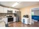 Bright kitchen features stainless steel appliances, granite counters, and ample cabinet space at 4409 Woodward Mill Rd, Sugar Hill, GA 30518