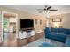 Open living room features hardwood floors, natural light, and a cozy sectional at 4409 Woodward Mill Rd, Sugar Hill, GA 30518