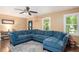 Inviting living room with a plush sectional, hardwood floors, and bright windows at 4409 Woodward Mill Rd, Sugar Hill, GA 30518