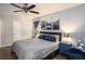 Comfortable main bedroom with a ceiling fan, wooden floors, mountain art, and natural light at 4409 Woodward Mill Rd, Sugar Hill, GA 30518
