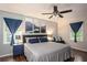 Spacious main bedroom with a ceiling fan, serene wall art, and bright natural light at 4409 Woodward Mill Rd, Sugar Hill, GA 30518