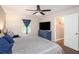 Relaxing bedroom featuring wood floors, a ceiling fan, a dresser, and access to en suite bathroom at 4409 Woodward Mill Rd, Sugar Hill, GA 30518