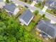 An aerial view captures the home's well-manicured lawn, backyard, patio, and neighboring houses in a suburban setting at 197 Cherokee Reserve Cir, Canton, GA 30115