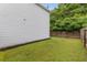 A charming backyard featuring a lush green lawn and a sturdy wooden fence for added privacy and security at 197 Cherokee Reserve Cir, Canton, GA 30115
