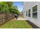 A well-maintained backyard with a grassy lawn, wooden fence, and a concrete patio, perfect for outdoor gatherings at 197 Cherokee Reserve Cir, Canton, GA 30115