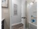 Bathroom featuring a shower-tub combo, gray wood floors, and gray walls at 197 Cherokee Reserve Cir, Canton, GA 30115